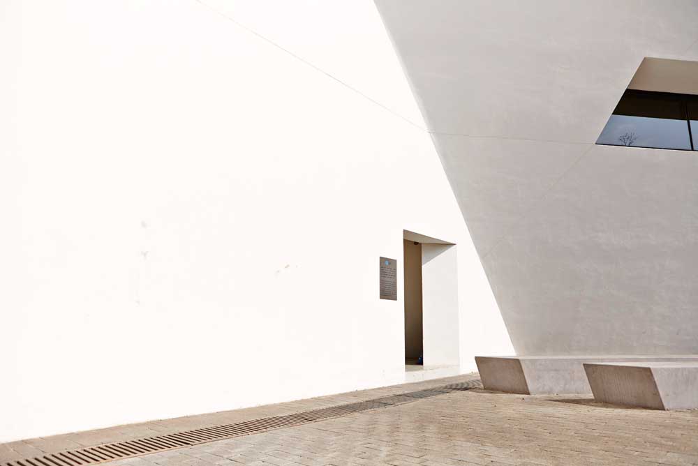 door way in white wall of libeskind building hong kong by airey spaces