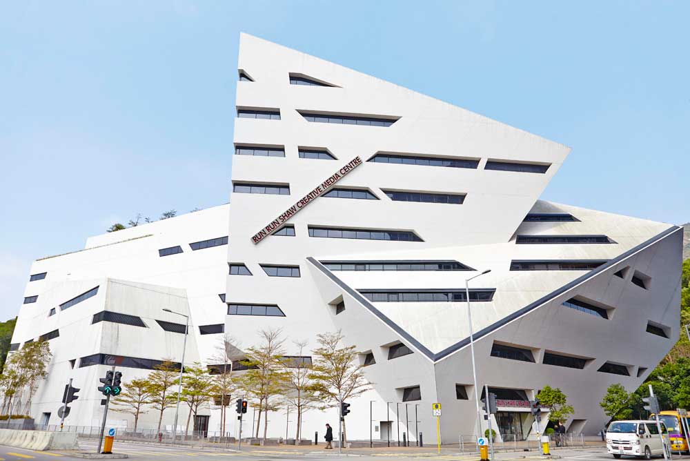 white angular libeskind building with blue sky in hong kong by airey spaces