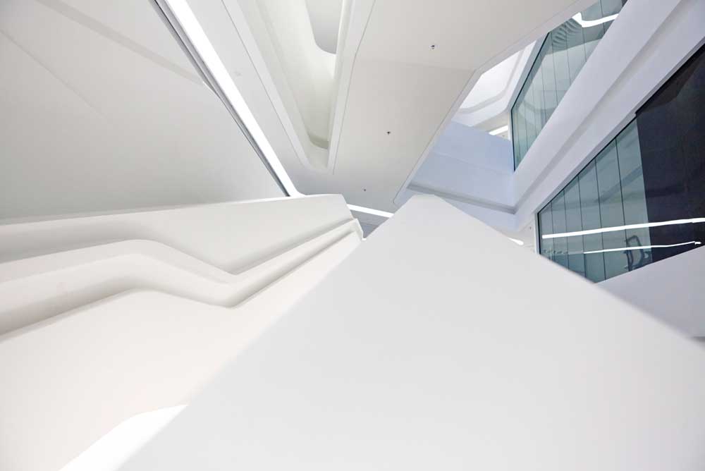 perspective view of all white staircase and atrium of innovation tower by airey spaces