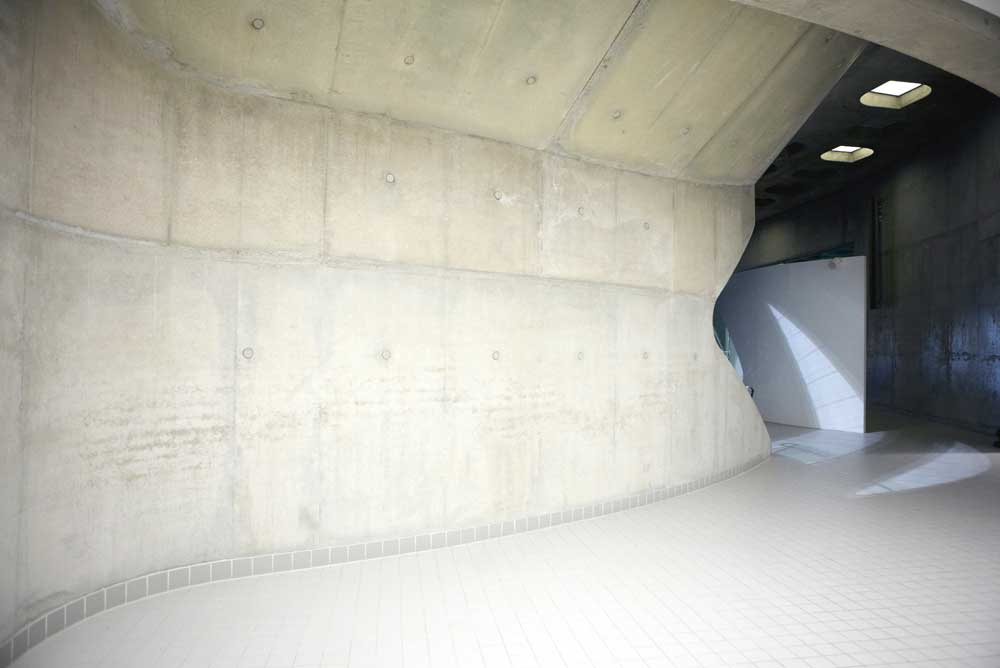 concrete and tile entrance to london olympic aquatic centre by airey spaces
