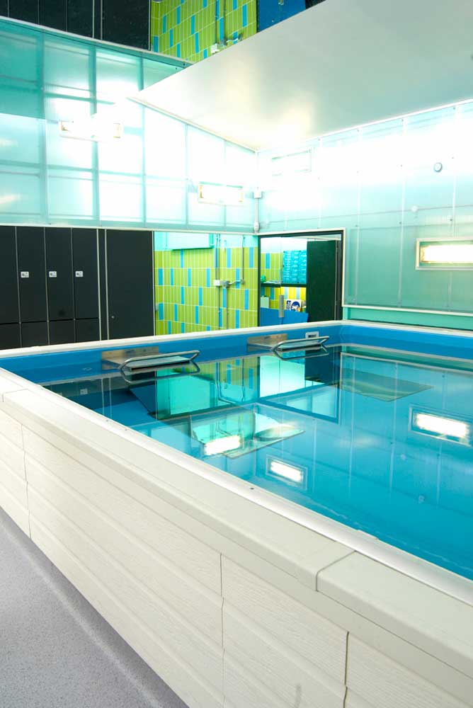 current swimming pool with mirror ceiling and black lockers by airey spaces