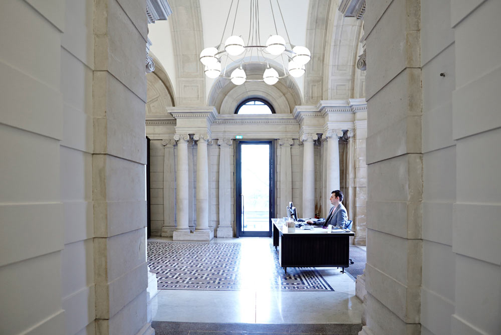 man at reception desk in tate britain reception area by airey spaces