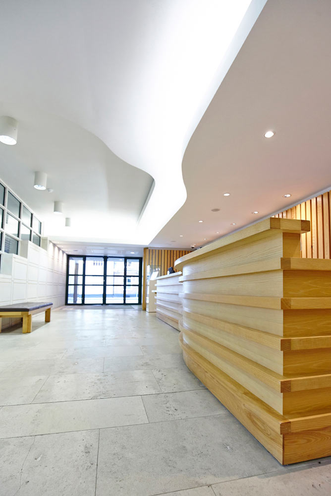 modern reception area with wood and glass in Pallant House Gallery by Airey Spaces