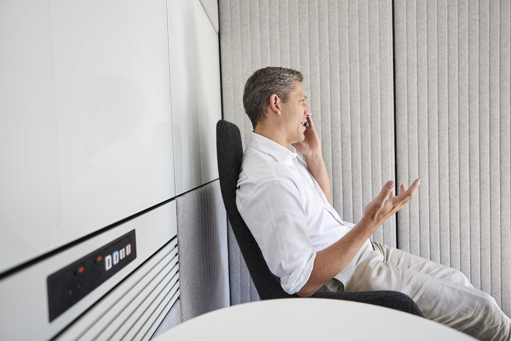 man on phone in sound booth in modern office