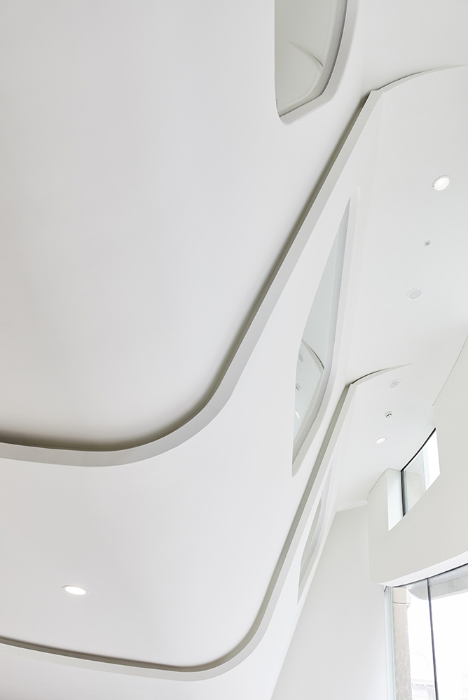 overhead white curved panelling with curved windows office interior by Airey spaces